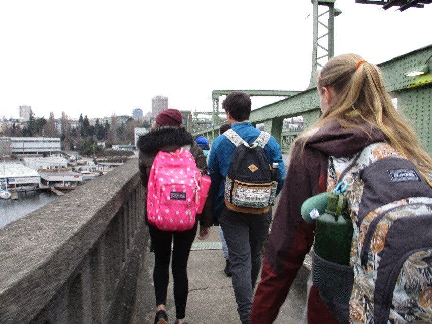 students with backpacks walking